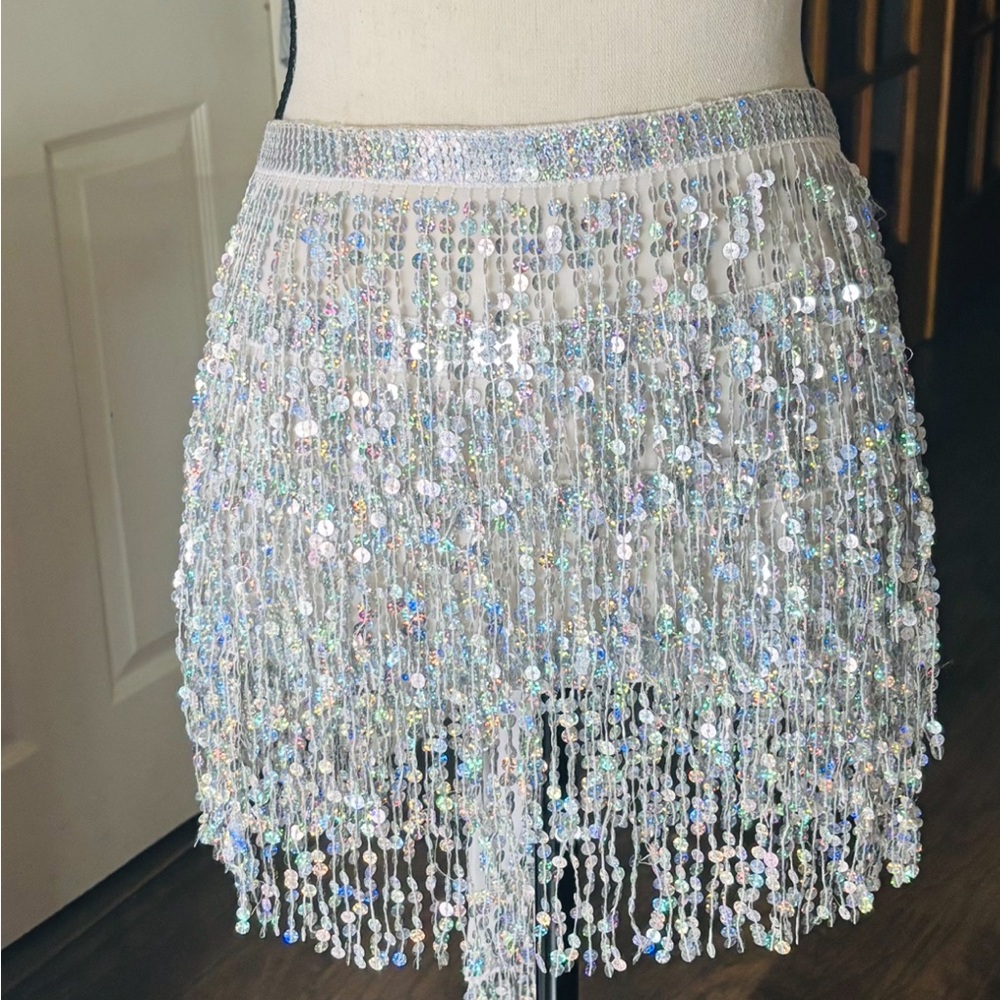 Silver sequined wrap around skirt.
Sequined tie belt.